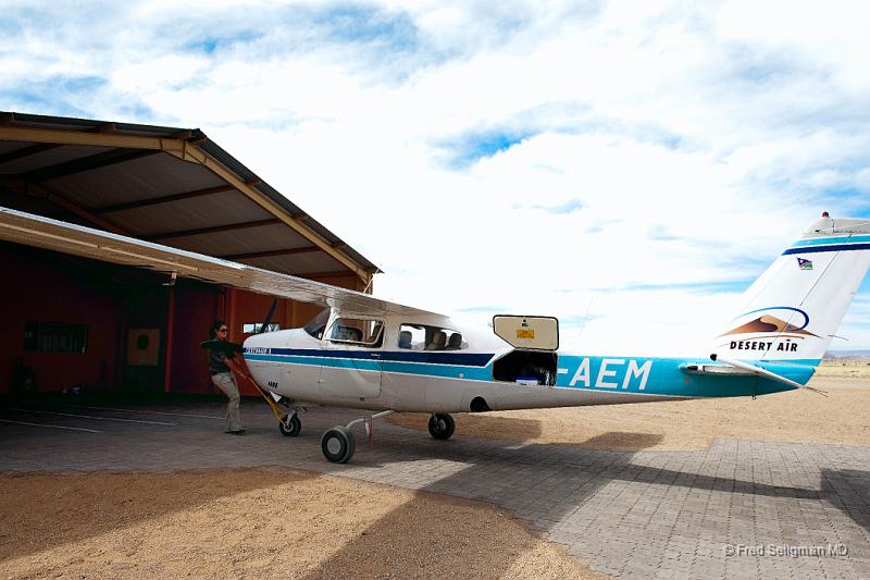 20090602_113651 D3 X1 V1.jpg - A pilot pushing out her plane from the hanger (garage)....for a sightseeing flight over the dunes